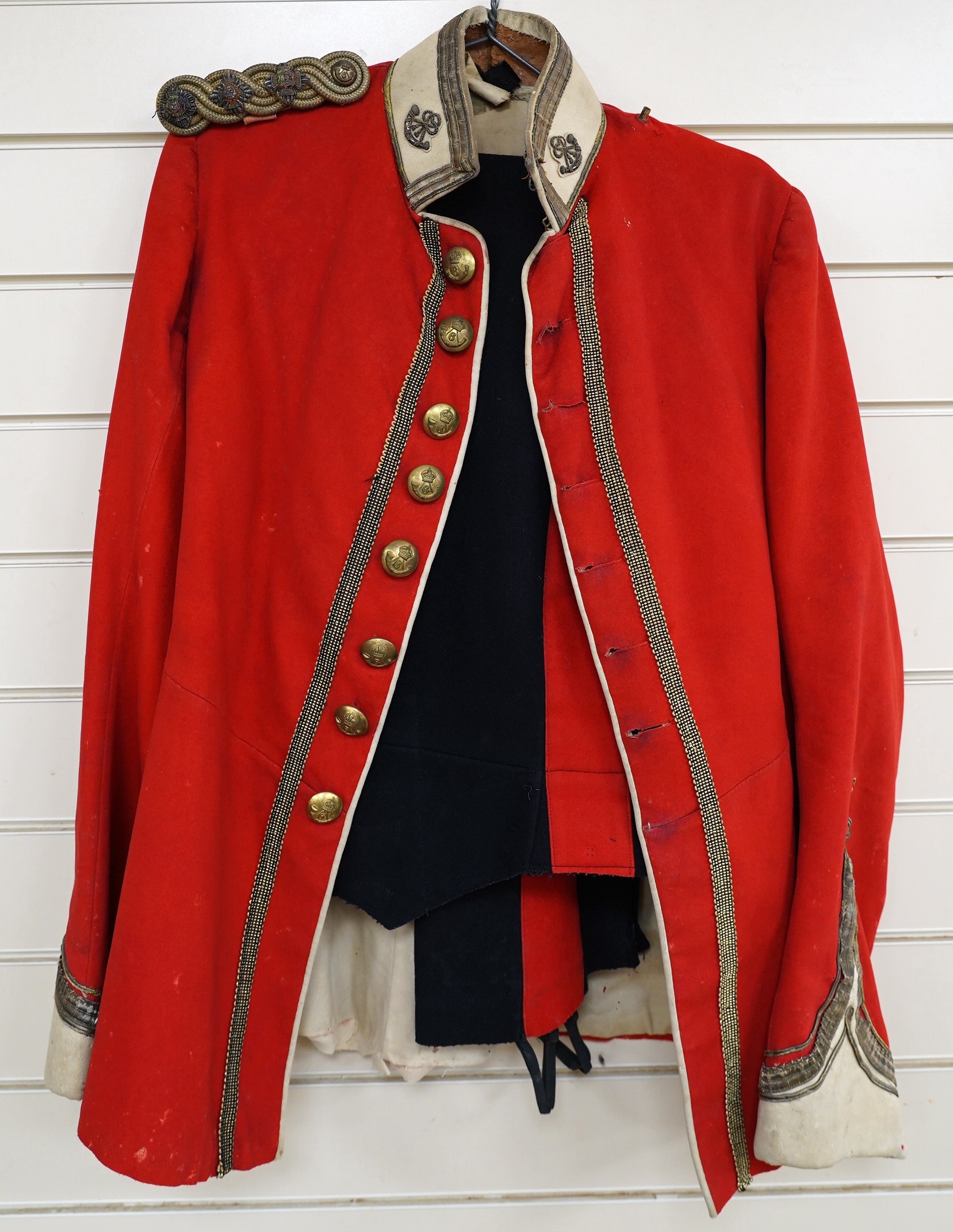 A Sixth Light Infantry officer’s uniform with epaulettes, comprising jacket and dress trousers. Condition - poor to fair, some staining and moth damage, etc.